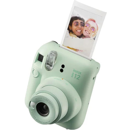 Mint green instant camera with a photo of two people on a white background